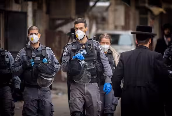 Zionist repressive agents close synagogues and disperse public gatherings in Jerusalem's Mea Shearim, March 31, 2020. Photo: Yonatan Sindel/Flash90.