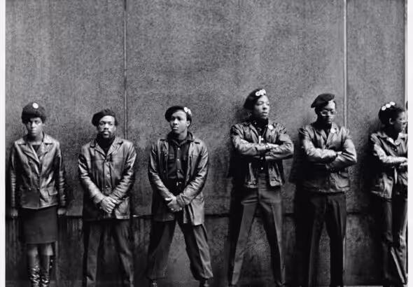 A line of Black Panther Party members as they stand outside the New York City courthouse under a portion of an Abraham Lincoln quote which reads 'The Ultimate Justice of the People.' April 11, 1969. Photo: David Fenton/Getty.
