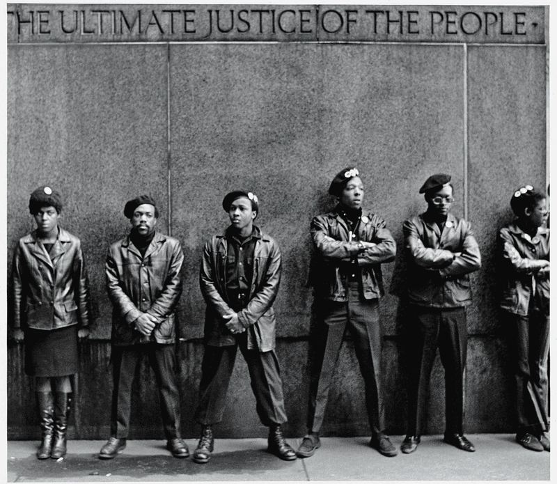 A line of Black Panther Party members as they stand outside the New York City courthouse under a portion of an Abraham Lincoln quote which reads 'The Ultimate Justice of the People.' April 11, 1969. Photo: David Fenton/Getty.