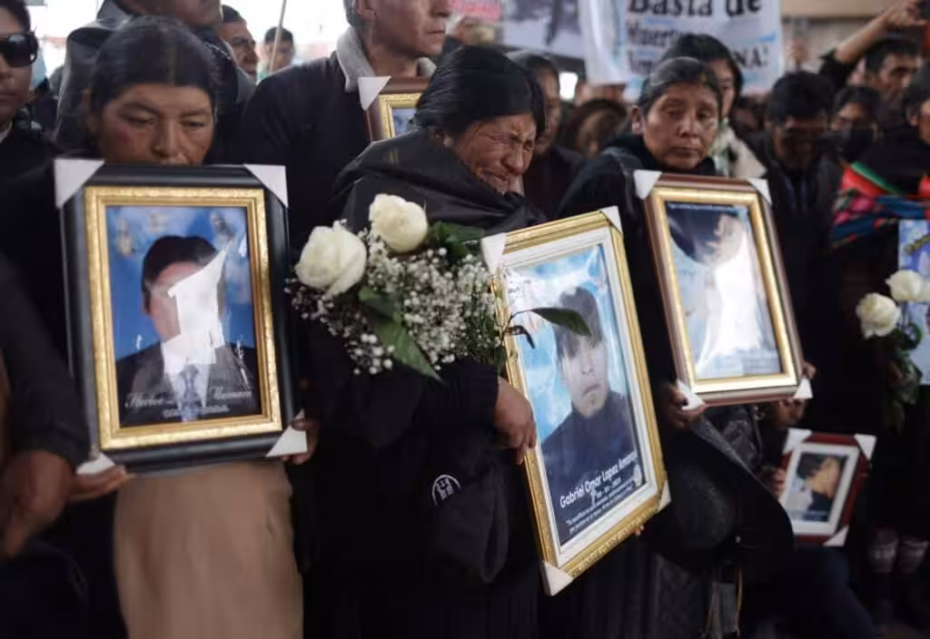 Families carry photos of victims killed by the armed forces in Juliaca, Peru February 9, 2023. Photo: REUTERS/Pilar Olivares.