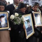 Families carry photos of victims killed by the armed forces in Juliaca, Peru February 9, 2023. Photo: REUTERS/Pilar Olivares.
