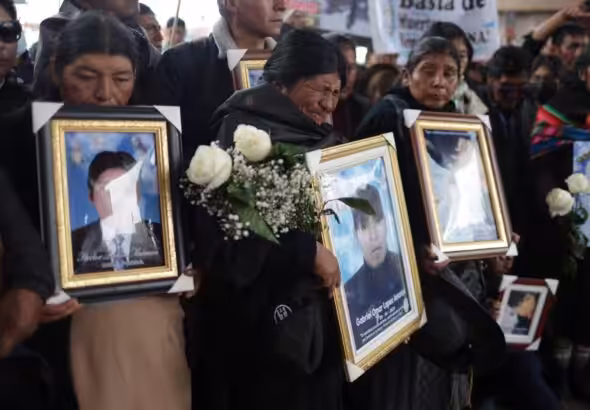 Families carry photos of victims killed by the armed forces in Juliaca, Peru February 9, 2023. Photo: REUTERS/Pilar Olivares.