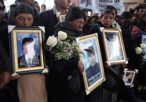Families carry photos of victims killed by the armed forces in Juliaca, Peru February 9, 2023. Photo: REUTERS/Pilar Olivares.