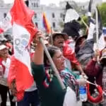 Protesters, consisting of indigenous activists and workers, raise flags in Plaza San Martín, Lima, Peru in opposition to the coup government of Dina Boluarte, January 2023. Photo: La Tercera.