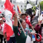 Protesters, consisting of indigenous activists and workers, raise flags in Plaza San Martín, Lima, Peru in opposition to the coup government of Dina Boluarte, January 2023. Photo: La Tercera.
