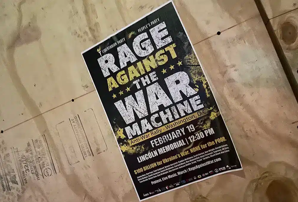 Photo of a poster for the “Rage Against the War Machine” event, organized in Washington DC on February 19, 2023. Photo: WorldBeyondWar.org.