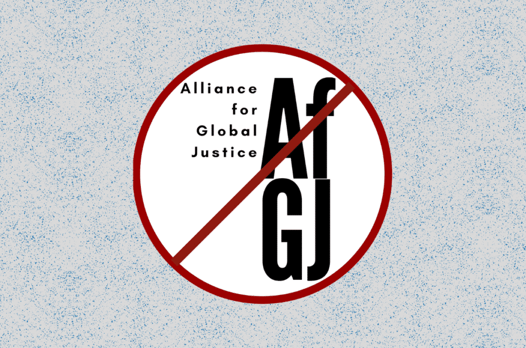 Alliance for Global Justice logo within a circle, with a cross line above it. Photo: Mondoweiss.
