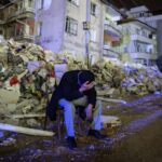 An elderly man sits amongst rubble after a 6.3 magnitude earthquake in Hatay, Türkiye, on February 20, 2023. Photo: Erdem Sahin/EPA-EFE/Shutterstock.