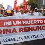 Peruvian protesters in the streets holding a banner that reads "Not one more death! Dina resign now!" File photo.