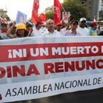 Peruvian protesters in the streets holding a banner that reads "Not one more death! Dina resign now!" File photo.