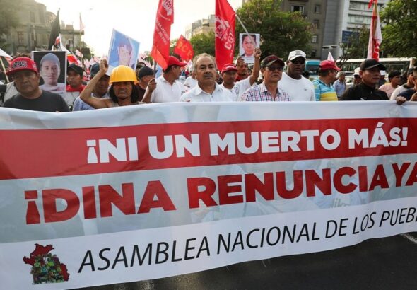 Peruvian protesters in the streets holding a banner that reads "Not one more death! Dina resign now!" File photo.
