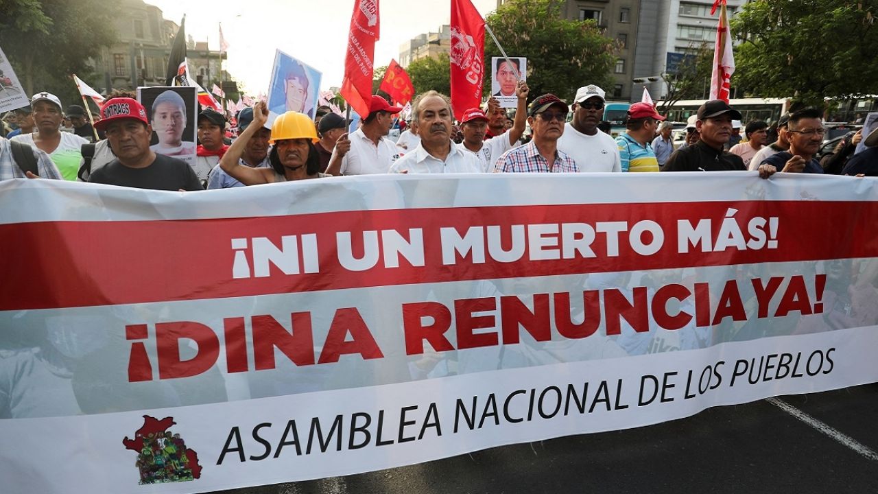Peruvian protesters in the streets holding a banner that reads "Not one more death! Dina resign now!" File photo.