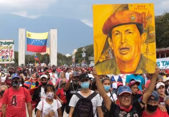 Chavistas marching and holding a large drawing of Commander Hugo Chávez at Paseo Los Proceres, Caracas, celebrating the 31st anniversary of the February 4th, 1992, military rebellion. Photo: Peoples Dispatch.