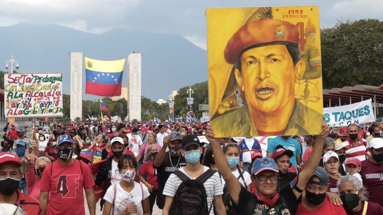 Chavistas marching and holding a large drawing of Commander Hugo Chávez at Paseo Los Proceres, Caracas, celebrating the 31st anniversary of the February 4th, 1992, military rebellion. Photo: Peoples Dispatch.