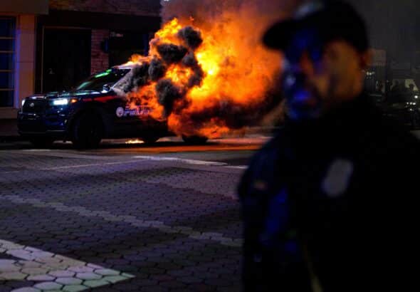 An Atlanta police vehicle set on fire during a Stop Cop City protest in Atlanta, Ga. Photo: Benjamin Hendren/Anadolu Agency via Getty Images.