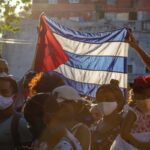 Cubans raising their flag in a rally. Photo: Ricardo IV Tamayo.