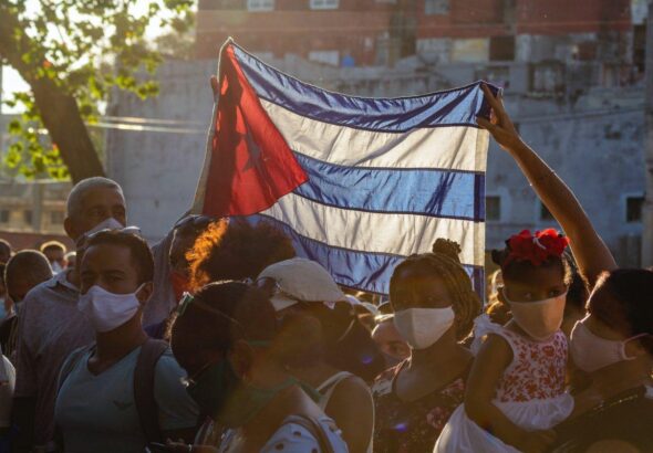 Cubans raising their flag in a rally. Photo: Ricardo IV Tamayo.