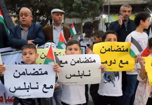 Palestinians take part in a rally in Jabaliya refugee camp in solidarity with West Bank Palestinians and political prisoners in Israeli jails, march 5, 2023. Children carry posters that read “in solidarity with Nablus”. Photo: Youssef Abu Watfa/APA Images.