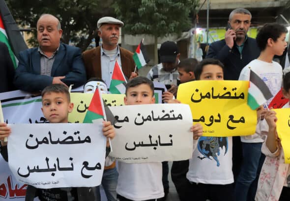 Palestinians take part in a rally in Jabaliya refugee camp in solidarity with West Bank Palestinians and political prisoners in Israeli jails, march 5, 2023. Children carry posters that read “in solidarity with Nablus”. Photo: Youssef Abu Watfa/APA Images.