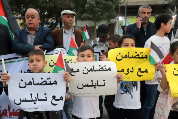 Palestinians take part in a rally in Jabaliya refugee camp in solidarity with West Bank Palestinians and political prisoners in Israeli jails, march 5, 2023. Children carry posters that read “in solidarity with Nablus”. Photo: Youssef Abu Watfa/APA Images.