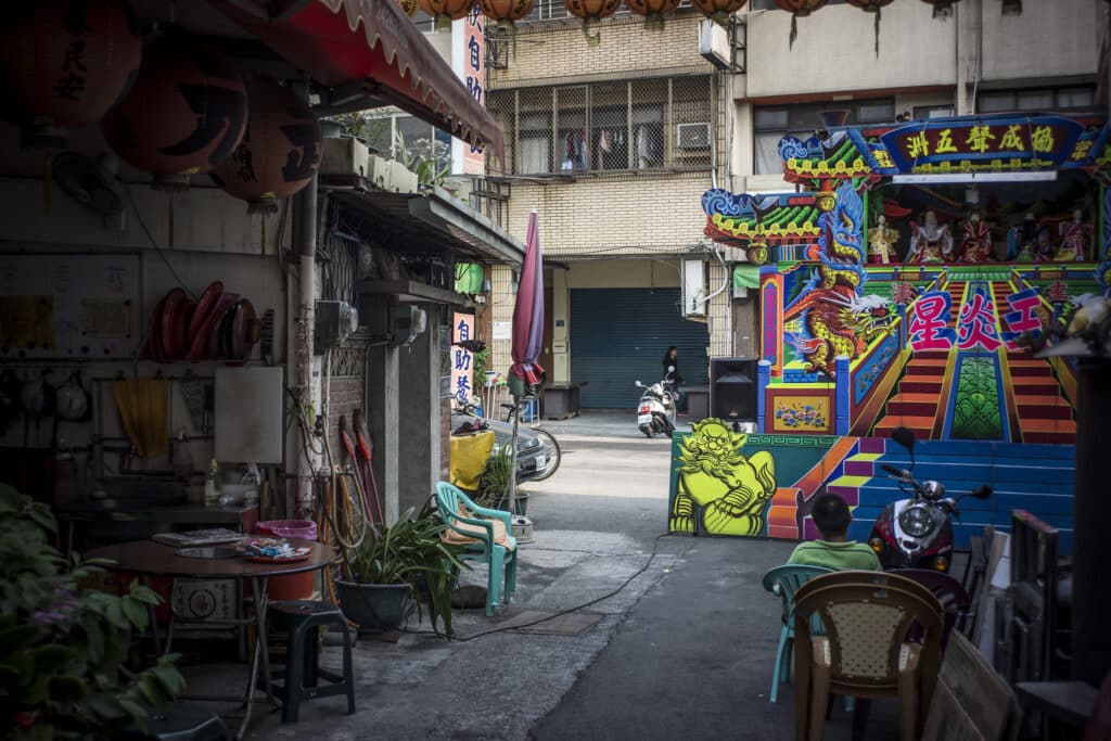 Ordinary Asian street with a set up for a puppet theater. Photo: File photo.