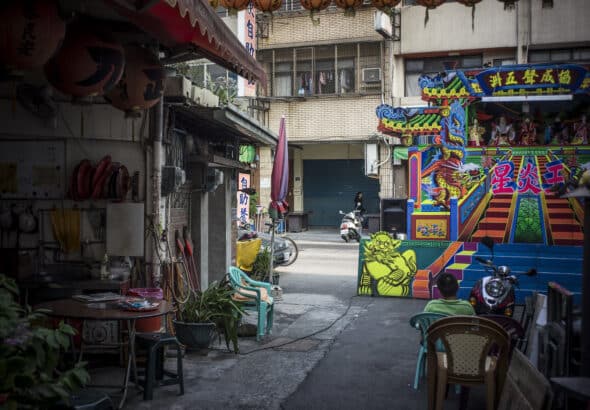 Ordinary Asian street with a set up for a puppet theater. Photo: File photo.
