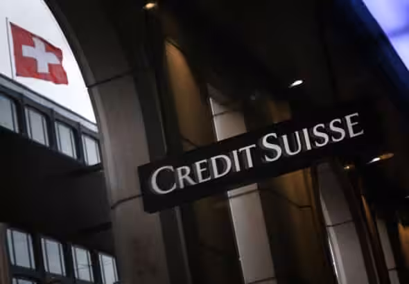 A Credit Suisse building with a reflection of a Swiss flag from a neighboring building. Photo: Fabrice Coffrini/AFP/Getty images.