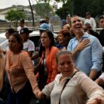 Disqualified opposition candidate Juan Guaidó smiles at supporters during a 2022 rally in Caracas. Photo: REUTERS/Gaby Oraa.