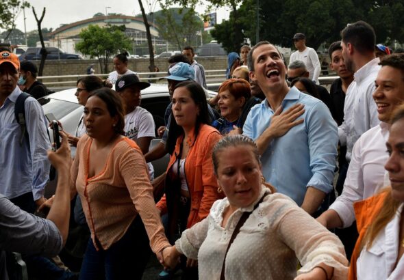 Disqualified opposition candidate Juan Guaidó smiles at supporters during a 2022 rally in Caracas. Photo: REUTERS/Gaby Oraa.