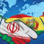 Photographic composition, in the background the globe and in front the flags of Iran and Bolivia shaking hands. Photo: Kawsachun News.