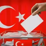 Illustration of a ballot box with a person casting a vote, with the Turkish flag in the background. Photo: Twitter/@eevriviade.