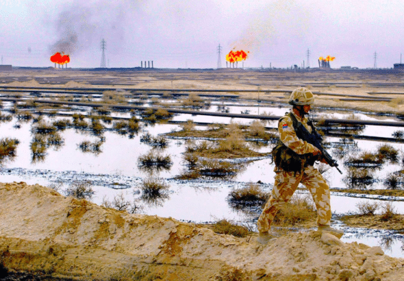 A British soldier patrols the Rumaila oil field in southern Iraq, 1 February 2005. BP was awarded the contract to be lead operator of the field four years later. Photo: Andrew Parsons/AFP via Getty.