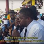 Caption: G9 Family and Allies leader Jimmy Cherizier speaks at a rally demanding an end to the Western puppet government of Haiti. Video source: Another Vision: Inside Haiti's Uprising | Episode 3: A Burgeoning Revolution, 28:02.