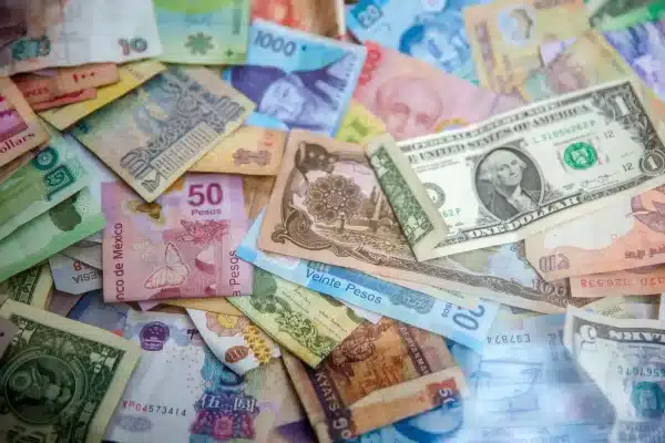A pile of Latin American bills with a US dollar in the middle. Photo: Jason Leung/Unsplash/File photo.