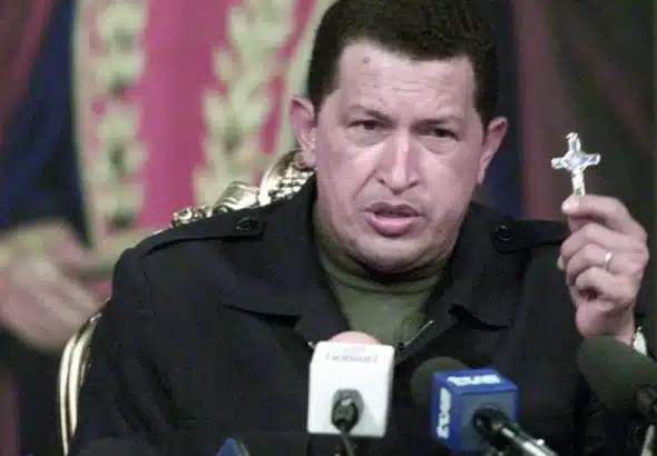 Venezuelan President Hugo Chávez holding a small crucifix in his hand in a televised address to the nation minutes after being reinstated as president as the result of a failed coup d'etat against him on April 11, 2002. Photo: Con el Mazo Dando/File photo.