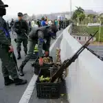 Rebel soldiers organize two plastic containers, one with bananas and the other full of ammunition, over the Altamira bridge in Caracas during the "banana coup," when Juan Guaidó, Leopoldo Lopez and other far-right opposition forces organized a coup against Venezuelan President Nicolás Maduro, on April 30, 2019. Photo: AP/File photo.