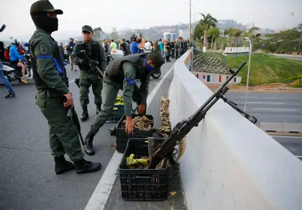 Rebel soldiers organize two plastic containers, one with bananas and the other full of ammunition, over the Altamira bridge in Caracas during the "banana coup," when Juan Guaidó, Leopoldo Lopez and other far-right opposition forces organized a coup against Venezuelan President Nicolás Maduro, on April 30, 2019. Photo: AP/File photo.