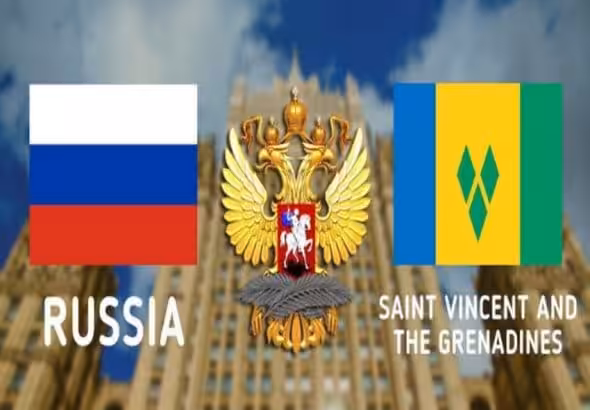Photo composition: Russian flag (left), Russian coat of arms (center), flag of Saint Vincent and the Grenadines (right), in the background the Ministry of Foreign Affairs of the Russian Federation.