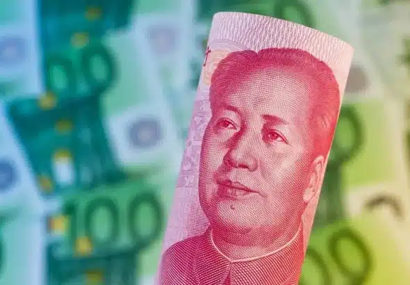 A banknote of China's 100 yuan with a portrait of Mao Zedong over a blurred background of euro banknotes. Photo: Gina Sanders/Fotolia via Wodicka.