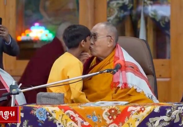 Screenshot from a viral video showing the Dalai Lama molesting a child on a televised program in India. Photo: Social media.