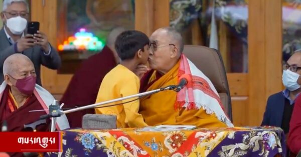 Screenshot from a viral video showing the Dalai Lama molesting a child on a televised program in India. Photo: Social media.