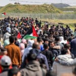 Palestinians rally while carrying flags and chanting "freedom" in the Gaza Strip. Photo: IMEMC.