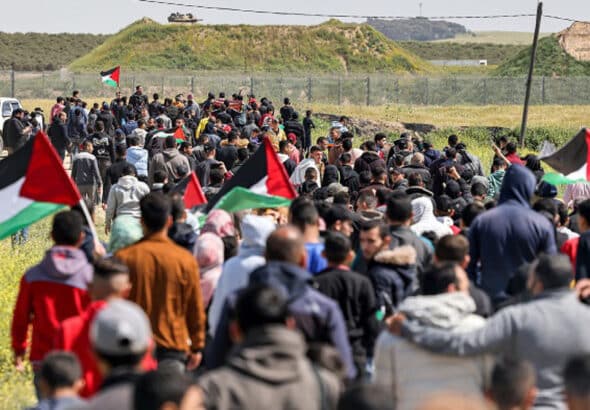 Palestinians rally while carrying flags and chanting "freedom" in the Gaza Strip. Photo: IMEMC.