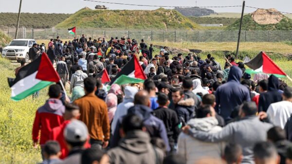 Palestinians rally while carrying flags and chanting "freedom" in the Gaza Strip. Photo: IMEMC.