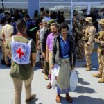 Freed Houthi prisoners stand as they wait to board an International Committee of the Red Cross (ICRC)-chartered plane at Aden Airport, in Aden, Yemen, Friday, April 15, 2023. Photo: Fawaz Salman/Reuters.