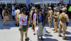 Freed Houthi prisoners stand as they wait to board an International Committee of the Red Cross (ICRC)-chartered plane at Aden Airport, in Aden, Yemen, Friday, April 15, 2023. Photo: Fawaz Salman/Reuters.