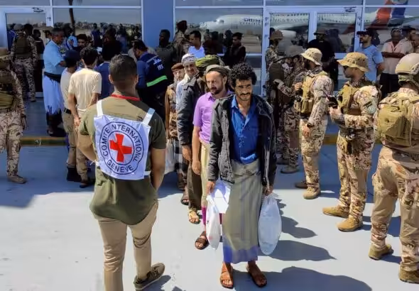 Freed Houthi prisoners stand as they wait to board an International Committee of the Red Cross (ICRC)-chartered plane at Aden Airport, in Aden, Yemen, Friday, April 15, 2023. Photo: Fawaz Salman/Reuters.