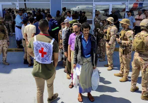 Freed Houthi prisoners stand as they wait to board an International Committee of the Red Cross (ICRC)-chartered plane at Aden Airport, in Aden, Yemen, Friday, April 15, 2023. Photo: Fawaz Salman/Reuters.
