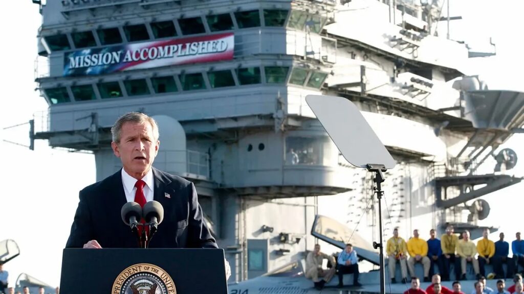 Former US President George W. Bush addresses the nation aboard the nuclear aircraft carrier USS Abraham Lincoln on 1 May 2003. Photo: Stephen Jaffe/AFP via Getty Images.