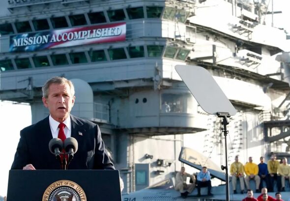 Former US President George W. Bush addresses the nation aboard the nuclear aircraft carrier USS Abraham Lincoln on 1 May 2003. Photo: Stephen Jaffe/AFP via Getty Images.